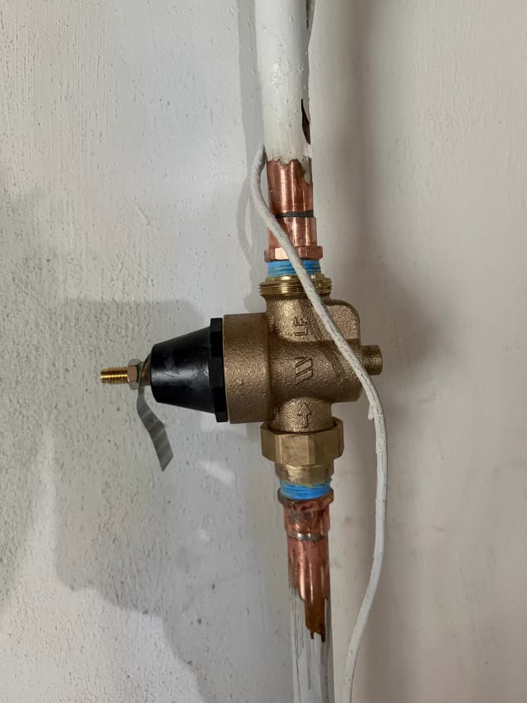 After: new brass pressure reducing valve installed on copper water supply line — Oopsie Daisy Plumbing Northern Colorado