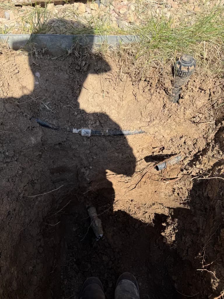 Before: excavated yard trench exposing damaged sewer line — Oopsie Daisy Plumbing sewer repair, Northern Colorado