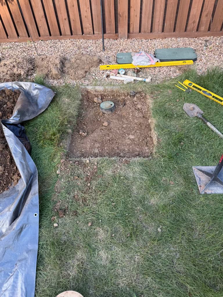 During: sewer cleanout installation in progress in fenced backyard — Oopsie Daisy Plumbing plumbing Northern Colorado