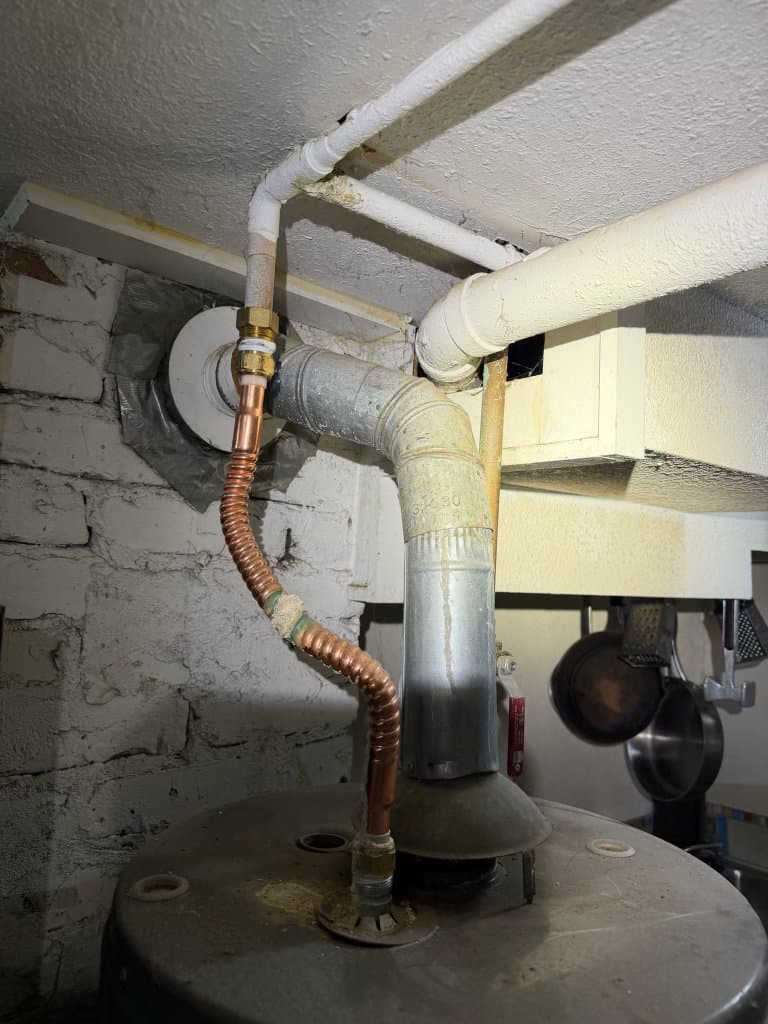 During: new copper connections and flex connector being installed on water heater — Oopsie Daisy Plumbing Northern Colorado