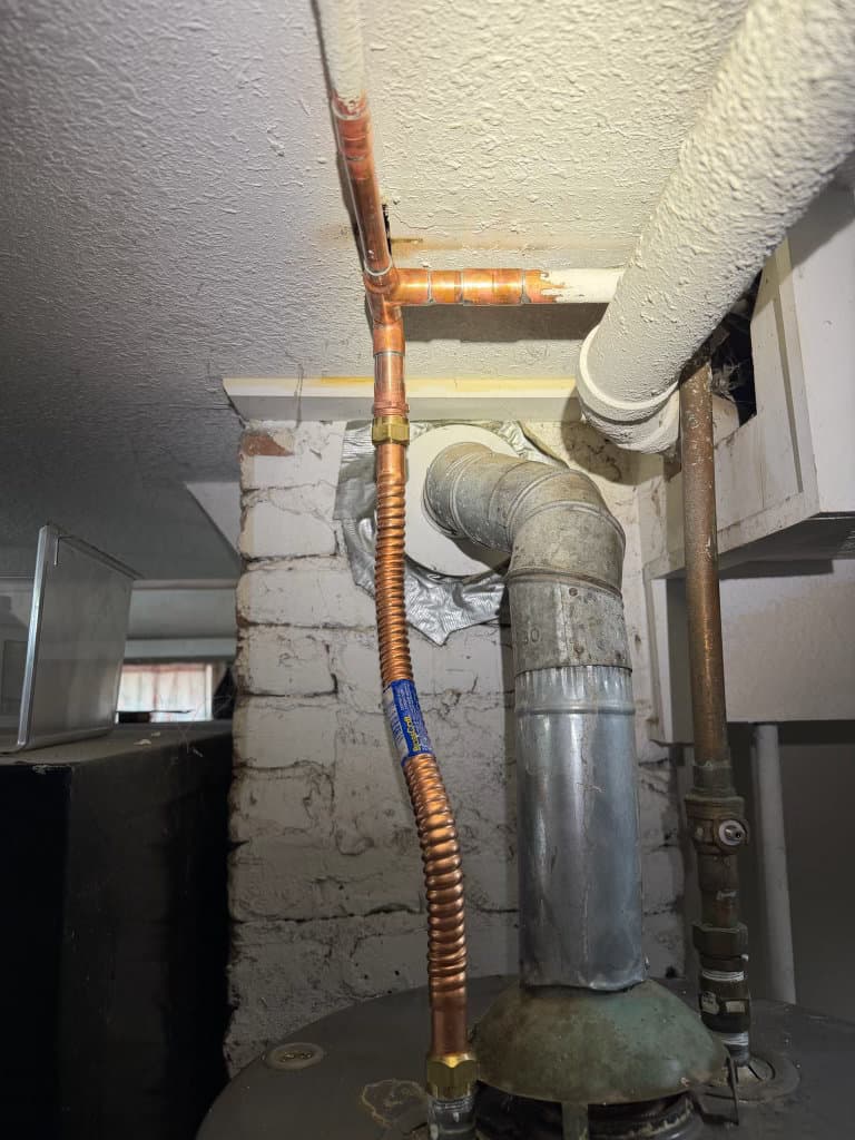 During: new copper supply T-fitting and flex connector on water heater — Oopsie Daisy Plumbing water heater repair Northern Colorado